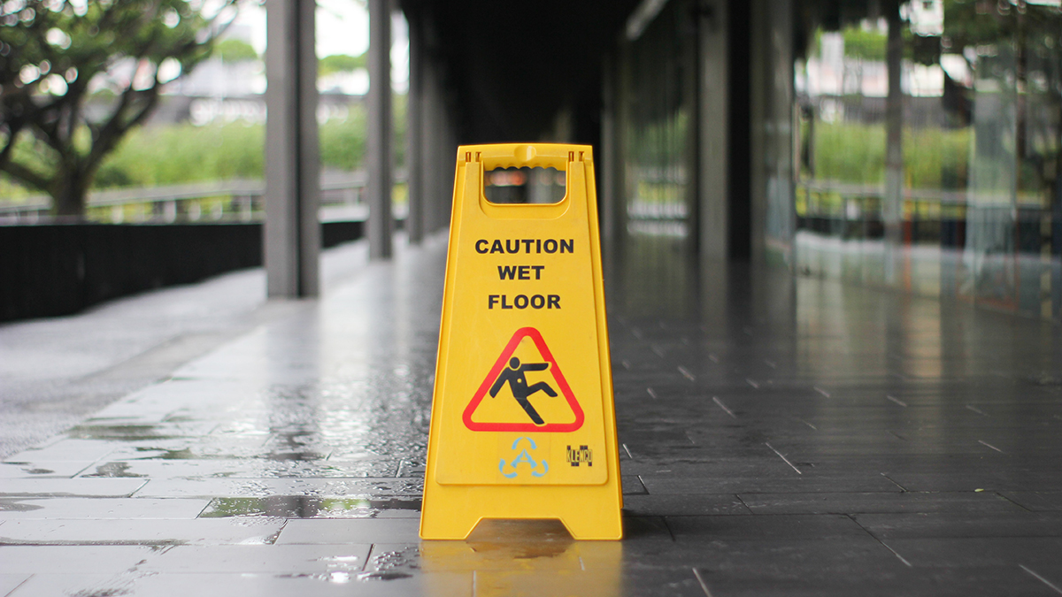 Caution sign on a wet outdoor walkway