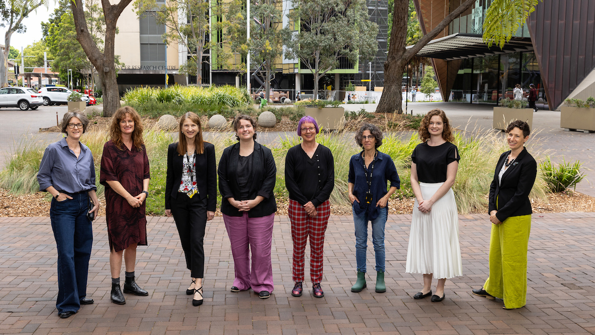 UNSW's Athena Swan Self Assessment Team standing outside the Chancellery with Clancy Auditorium in the background