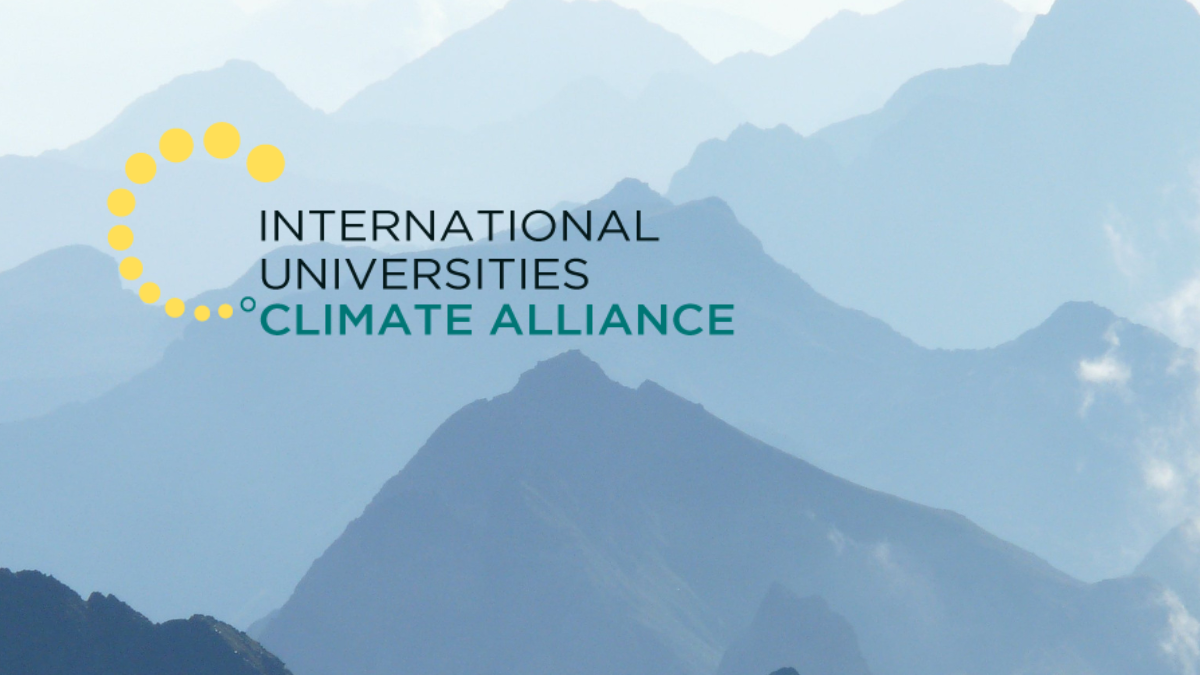 International Universities Climate Alliance logo over a photo of grey mountains