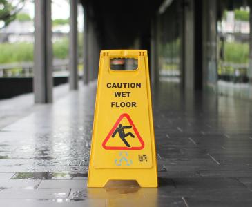 Caution sign on a wet outdoor walkway