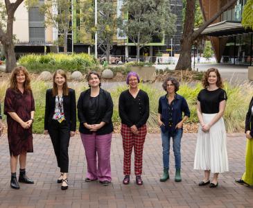 UNSW's Athena Swan Self Assessment Team standing outside the Chancellery with Clancy Auditorium in the background