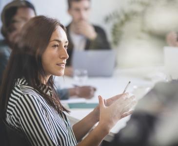 A woman speaking at a meeting