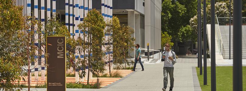 A man walking past the MCIC